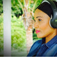 Woman wearing black and gray Things Audio FM radio over-ear headphones outdoors
