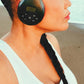 Person wearing black Things Audio over-ear FM radio headphones on the beach side view