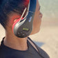 Person wearing black and red Things Audio FM radio over-ear headphones outdoors