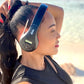 Person wearing black and red Things Audio FM radio over-ear headphones on the beach