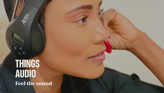 Person wearing Things Audio FM radio over-ear headphones listening to music