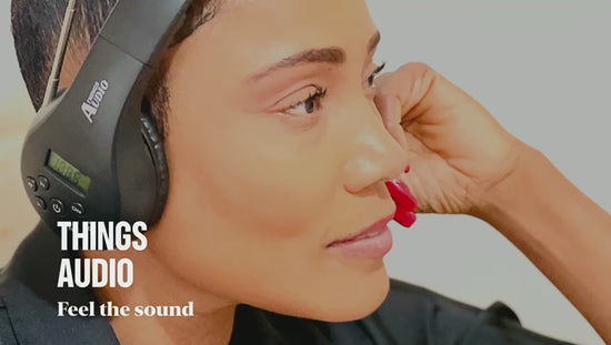 Person wearing black Things Audio over-ear FM radio headphones listening to music